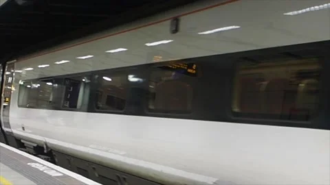 Side View Of A Train Pulling Into A Platform, UK Stock-Footage 136518783