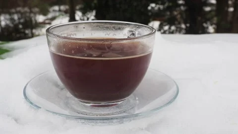 Side View Of A Transparent Cup Of Hot Black Coffee With Steam Rising From It, UK Stock Footage 153501243