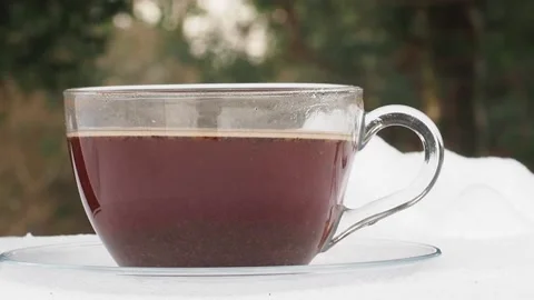 Side View Of A Transparent Cup Of Hot Coffee With Steam Rising From It, UK Stock Footage 153501262