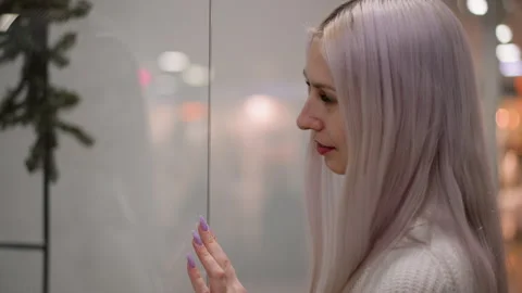 Side view trendsetter touching boutique window glass in admiration retail Stock Footage 316821036