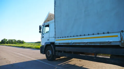 Side view of truck with cargo trailer driving on highway and transporting goods Stock Footage 335817359