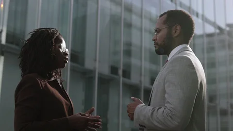 Side view of two confident managers talking outdoor. Stock Footage 114965892