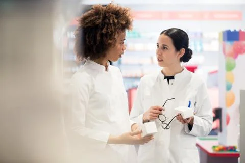 Side view of two dedicated pharmacists looking for the best medicine Stock Photos