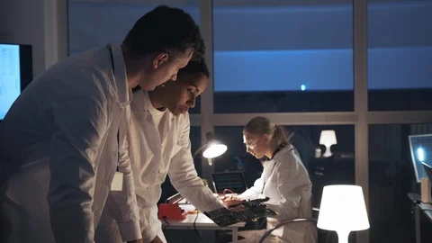 Side view of two Electronics Development Engineers talking about electronic Stock Footage 112918949