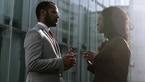 Side view of two self-assured workers talking outdoor. Stock Footage 114965198