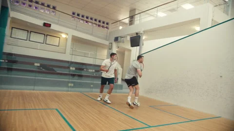 Side view of two squash players playing the game Stock Footage 278968902