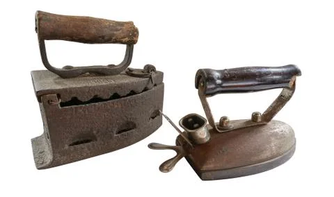 Side view of two vintage old rusty coal irons isolated in white background Stock Photos