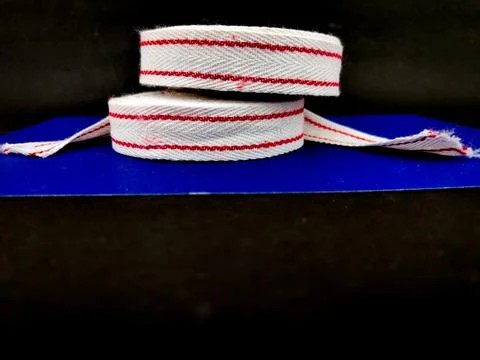 Side view of two White red cotton ribbon rolls. Used for clothing,packing,wra Stock Photos