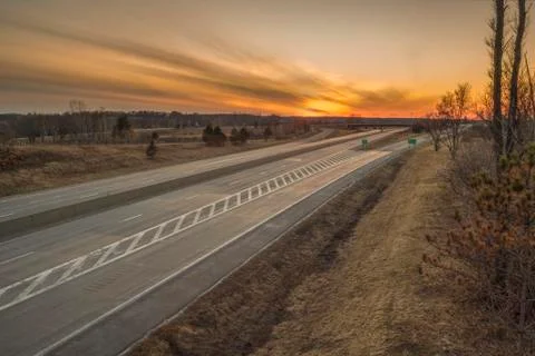 Side view of a typical US motorway after sunset, New York, USA. Stock Photos