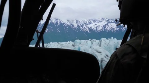 Side view of UH-60 Black Hawk helicopter flying over ice in Alaska Video stock 91168059