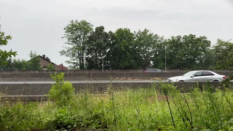 Side view of UK motorway traffic on a ra... | Stock Video | Pond5