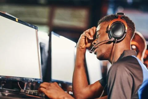 Side view of upset african guy, professional cybersport gamer looking at PC Stock Photos