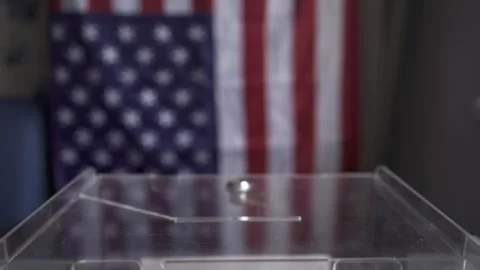Side view of US soldier hand putting ballot into transparent box slot, American 스톡 동영상 342246382