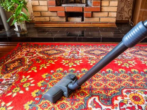 Side view of vacuum cleaner brush cleans carpet Stock Photos