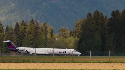 Side view of Valuejet passenger airplane taxiing on the taxiway Stock Footage 210215981