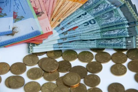 Side view of various Malaysia Ringgit currency and coins on white background Stock Photos