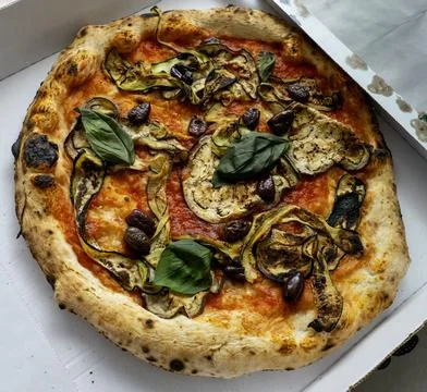 Side view on vegetable pizza with pepper and tomatoes Stock Photos