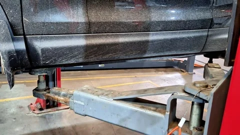 Side View of Vehicle Elevated on Hydraulic Lift in Automotive Workshop Video stock 331978846