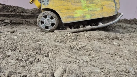 Side View of Vibratory Plate Compactor Leveling Soil on Site Stock Footage 332506459