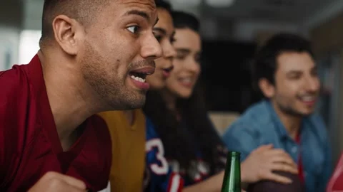 Side view video of friends watching Tv and cheering together Stock-Footage 131506962
