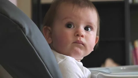 Side view video of small caucasian kid waiting for her parents to feed her Video stock 155753599