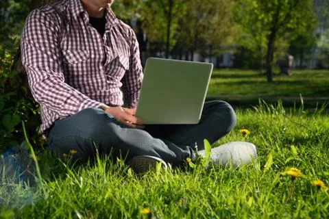 Side view View from above , young man is sitting under a tree on a sunny day. Stock Photos