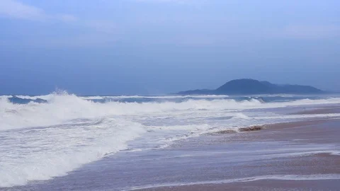 Side view of waves coming into the beach in slow motion on a windy day Stock Footage 87703113
