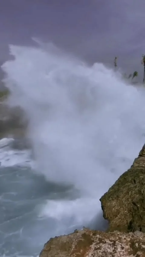 Side View of Waves Hitting the Beach Rocks Powerfully Stock Footage 311308587