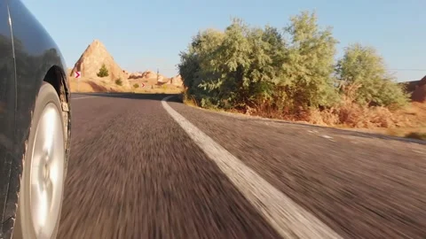 Side view of wheel spinning in fAst motion on asphalt road in turkey deserted Vidéo 188022878