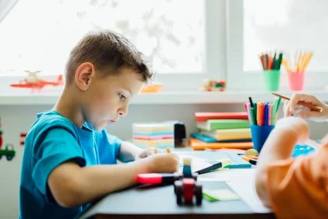 Side view of a whistling student doing his homework Stock Photos