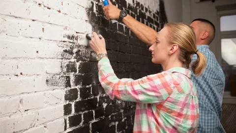 Side view of white multicultural couple doing house renovation together. White Stock Footage 195531033