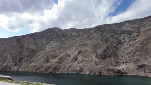Side View from a Winding Road, Overlooking a Tranquil Green Lake. Dark Mount Stock Footage 289193829