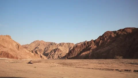 Side view from the window of fast moving car to the mountains in the desert at Stock Footage 251744538