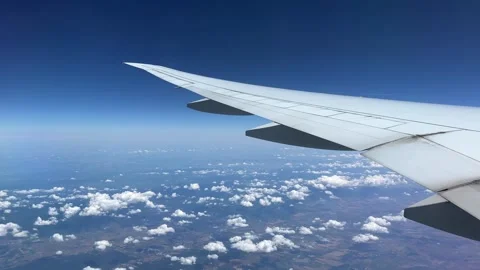 Side view from window of plane flying on clouds Stock Footage 259650551
