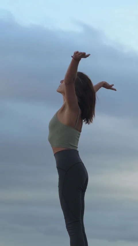 Side view of woman doing the sun salutation during a yoga session. Stock Footage 219565266