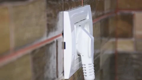 Side view of woman hand plugging and unplugging from the wall power socket. 動画素材 140987638