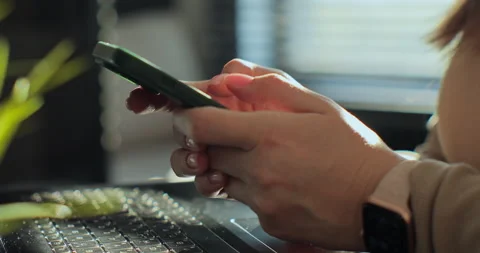 Side view. Woman hand using texting mobile phone at home morning. Close up of Stock Footage 254152580