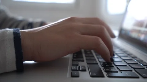 Side view of woman hands texting rapidly mail or chatting with friends on keyboa Stock Footage 98499097