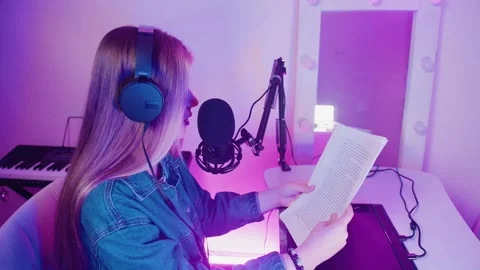 Side view of a woman sitting at a table and reading text from a piece of paper Stock Footage 309798448