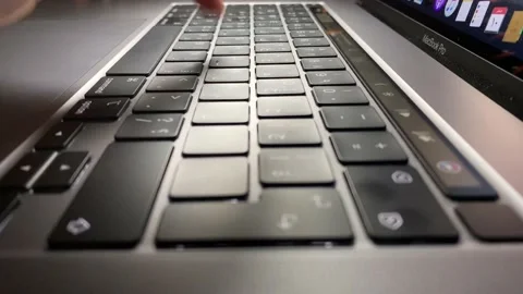 Side view of a woman typing on a keyboard Stock Footage