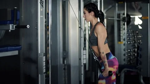 Side view of woman using exercise machine  Stock-Footage 73695481