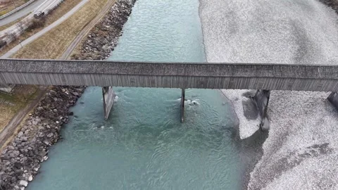 Side View of Wooden Bridge Over River with Water and Riverbed 스톡 동영상 329511680