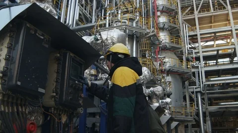 Side View Worker at Control Panel at Oil Refinery Complex Stock Footage 79207211