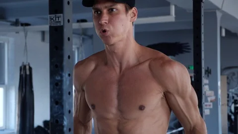 Side view of workouter doing parallel bar dips. Muscular young man doing triceps Stock-Footage 103347924