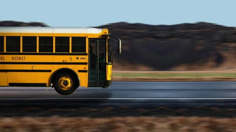 Side view of a Yellow Bus driving on highway at high speed, mountain background. Stock-Footage 332430235
