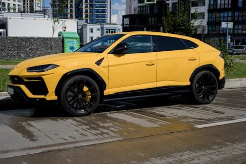 Side view Yellow Lamborghini Urus car. Stock Photos
