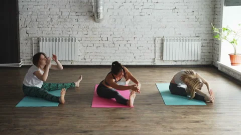 Side view of yoga students doing stretching exercises developing flexibility Video stock 89067005