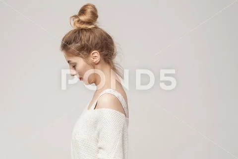 Side view young adult unwell blonde woman looking down. Stock Photos