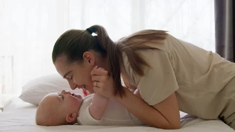 Side view, young and happy mother doing her morning routine of taking care of Stock Footage 304696413