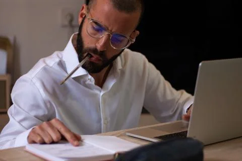 Side view of young architect with glasses working at home Stock Photos